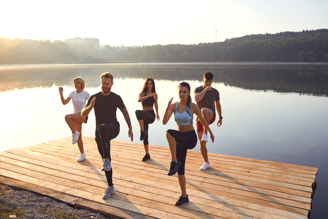 People Working Out by the Lake